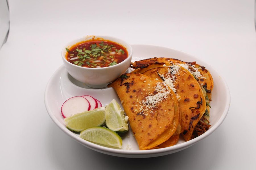 Crispy birria tacos with consommé and lime at La China Poblana